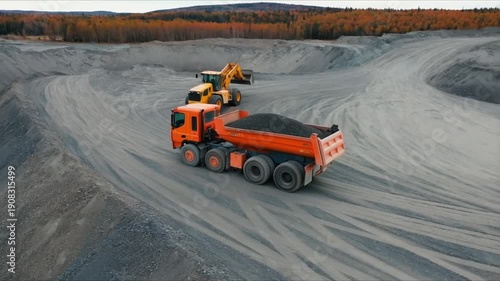 Wallpaper Mural Heavy machinery including a dump truck and excavator working in a large gravel quarry under a cloudy sky. Torontodigital.ca