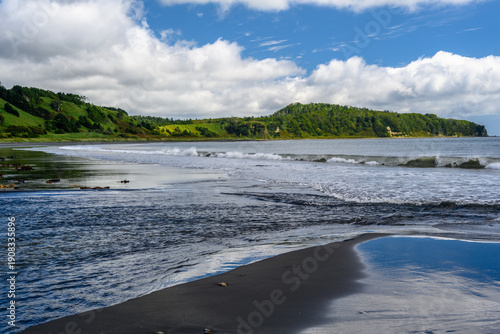 Fototapeta Surreal coastal view in Russia with waves lapping against the shore