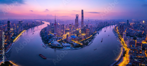 Majestic aerial view of the Shanghai skyline and Huangpu River at sunrise in China.