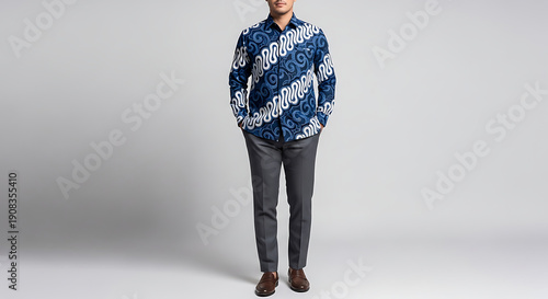 Man Wearing Blue Patterned Shirt and Grey Trousers Standing