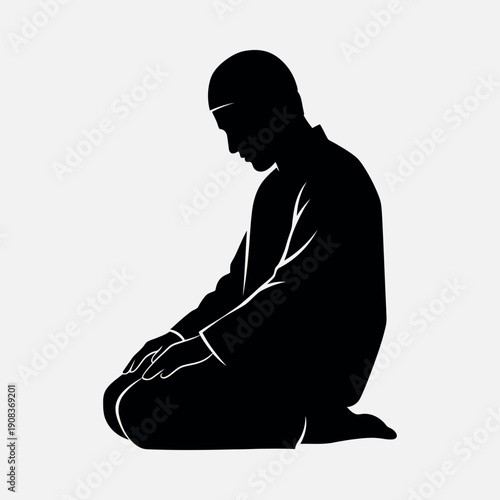 Man sitting in prayer with hands clasped in serene contemplation
