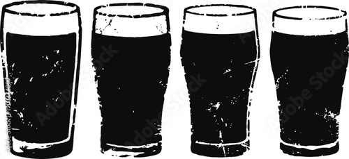 four full beer glasses with foam tops in a row isolated on white background