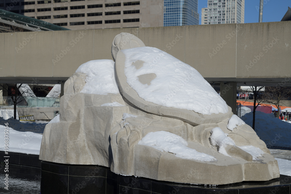 Fototapeta premium snow covered stone Turtle Sculpture by Solomon King at Spirit Garden at Nathan Phillips Square, Toronto