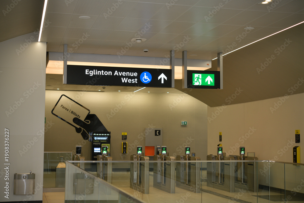 Fototapeta premium interior view of an Eglinton Line 5 station featuring entry gates and Presto vending machines, Toronto