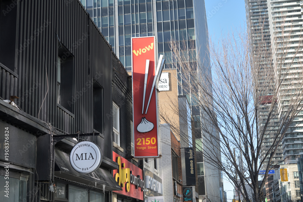 Fototapeta premium projecting signs on commercial buildings, Yonge St, incl Juicy Dumpling in Midtown 2150 Yonge St, Toronto