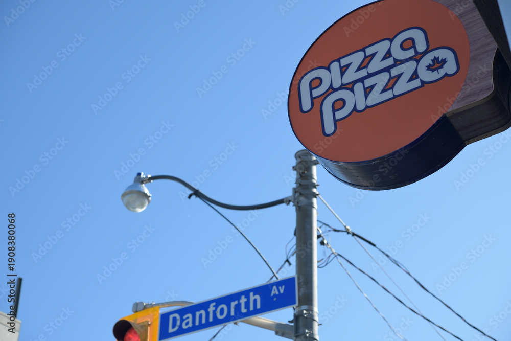 Fototapeta premium round projecting Pizza Pizza sign at 85 Danforth Av intersection of Broadview Av, Toronto