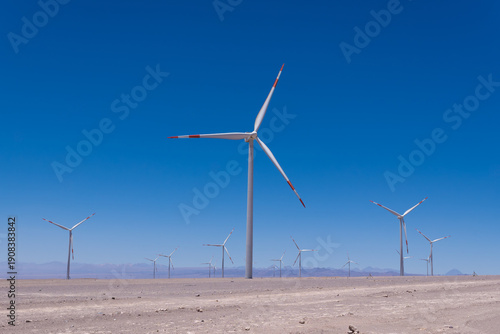 Foto Wind farm harnessing wind power for generating electricity in a dry climate, pro