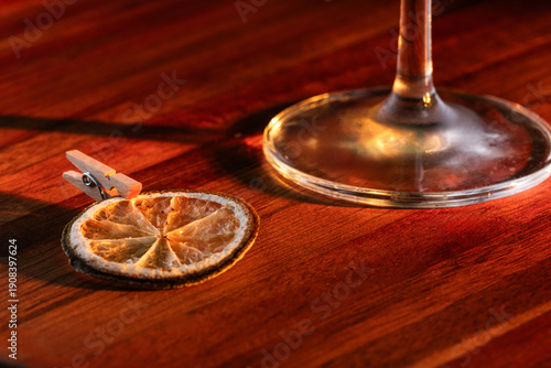 close up of a dehydrated lime and a small clothes pin to use as a cocktail garnish