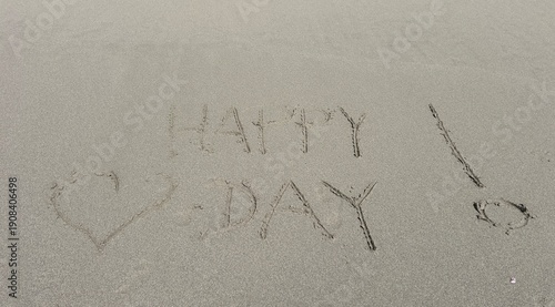 Happy Valentines day written in the sand