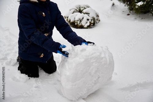 Child Rolling a Huge Snowball in Winter — Fun Outdoor Snow Activity