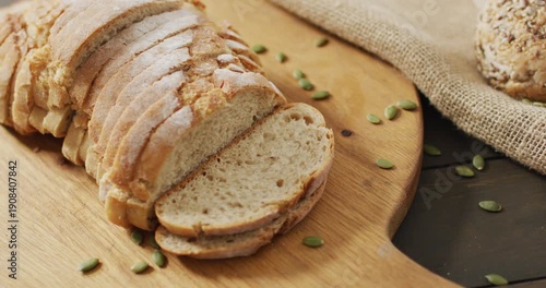 Video of bread on chopping wooden board on wooden worktop