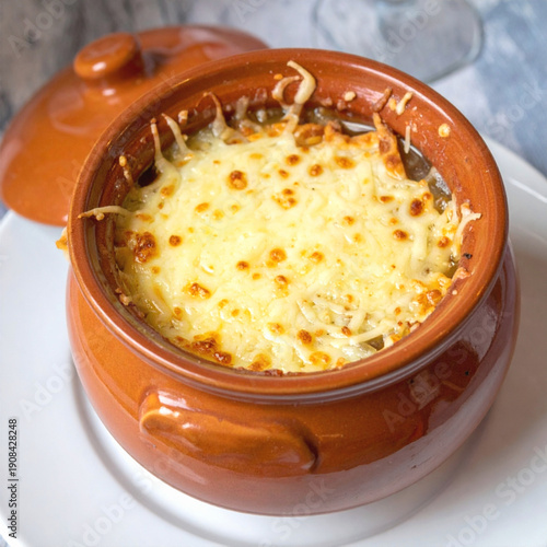 Classic French Onion Soup (Soupe à l'Oignon Gratinée) Served in a Traditional Earthenware Crock, Topped with Toasted Crouton and Melted Gruyère Cheese