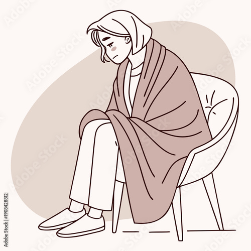 Woman sitting on chair wrapped in pink blanket looking unwell