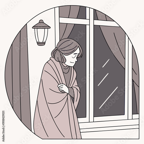 Woman wrapped in blanket looking out window on cold day