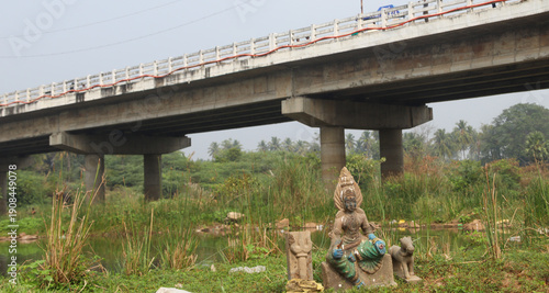 Photos View of  Damaged statue of a female deity near a river bank in Tamil Nadu kodive