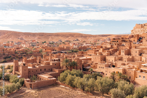Fotografie Moroccan kasbah Ait Ben Haddou with tourists exploring its ancient architecture