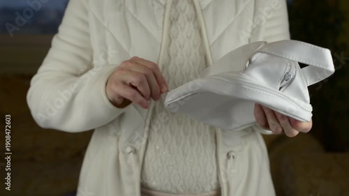 The rhythmic zipping and unzipping of a cosmetic pouch with the muffled friction of the zipper track with sound.