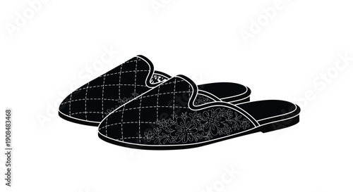 A pair of black and white checkered slip on loafers isolated on a white background