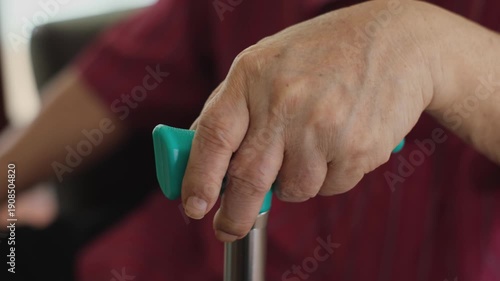 Wallpaper Mural Elderly hand holding walking cane while sitting, senior man resting hands on walking stick. Torontodigital.ca