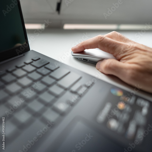 Man's hand pressing the left mouse button on a very close photo.