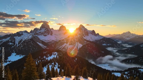 Majestic Snowy Mountain Peaks at Sunrise with Foggy Valleys