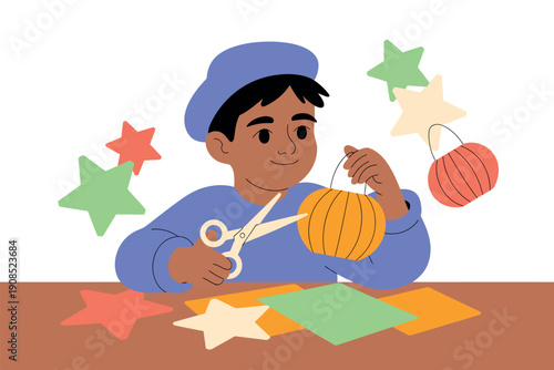 A young boy is crafting a colorful paper star decoration with scissors and glue