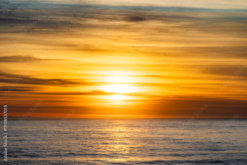 Obraz premium Golden Sunrise Over the Indian Ocean at Plettenberg Bay with Coastal Fynbos and Tsitsikamma Mountains 