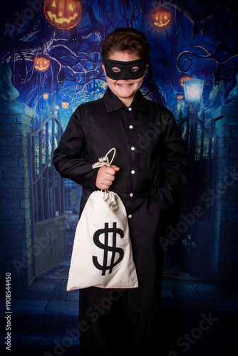 portrait of a boy in halloween costume as a thief, bank robber
