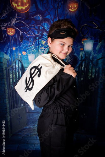 a boy in a black suit dressed as a thief