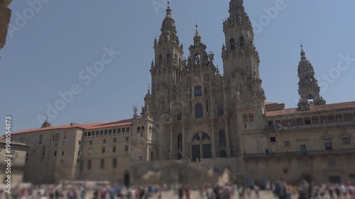 Establishing shot through arches toward Santiago de Compostela cathedral plaza