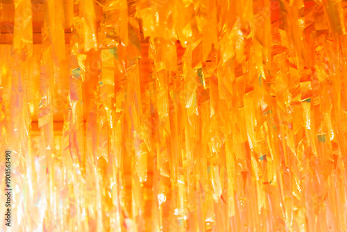 Foto Background image: yellow-orange stripes of fabric rustling in the wind