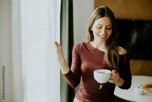 Woman enjoys hot drink whil...