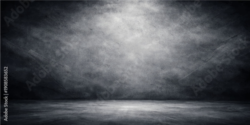 A dark and aged interior features a rough gray concrete wall texture meeting a dirty cement floor to create a blank vintage grunge backdrop for industrial design