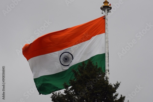 An Image of the Waving Indian Tricolour Flag in full spirit, high up the pole in the Capital City of one of the States in India.
