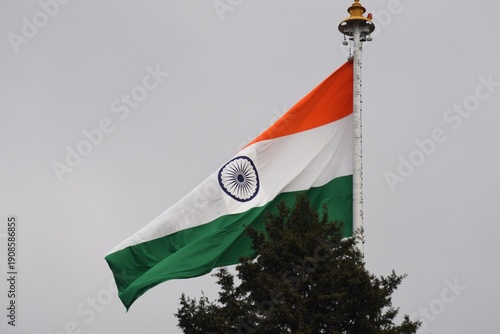 An Image of the Waving Indian Tricolour Flag in full spirit, high up the pole in the Capital City of one of the States in India.