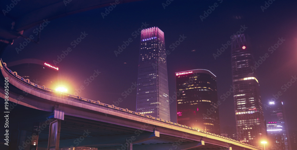 Fototapeta premium Neon City Skyline with Highway Overpass at Night