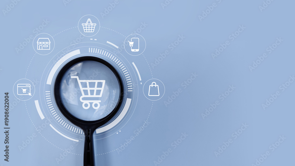 Fototapeta premium Magnifying glass on shopping cart icon representing e-commerce, online shopping, digital retail, and modern marketplace.
