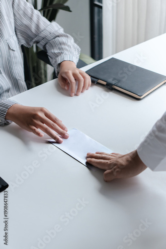 Business people giving a resign letter to quit a job at office