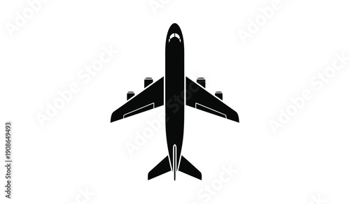 Black silhouette of an airplane flying high from above view