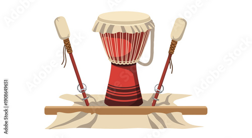 Traditional African djembe drum with drumsticks on wooden log isolated on a simple background