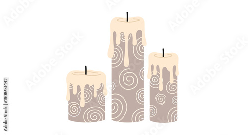 Three candles with swirl designs stand upright on a white surface viewed from a slightly elevated angle
