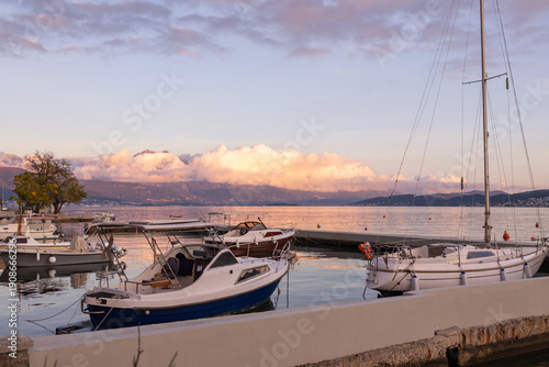 Sunset view of boats in the marina overlooking the mountains in Herceg Novi Montenegro