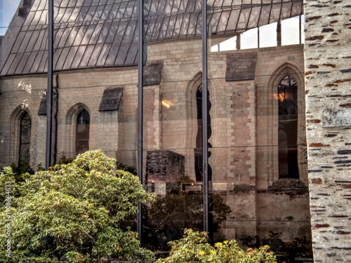 Angers, France - August 3rd 2012: View of the Musée David d'Angers reflected in the glass facade of a nearby building in the city center.