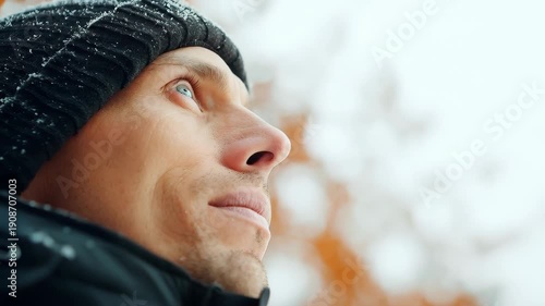 Serene Contemplation: Portrait of a man gazes skyward amidst a gentle snowfall, encapsulating the serenity of the moment, and the peace of mind.