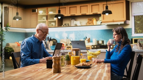 Cuadro en lienzo Elderly retired woman ignoring husband and being zoned out, defocused absent person sitting at the table and being preoccupied