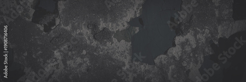 Dark wide panoramic background. Peeling paint on a concrete wall. Faded dark texture of old cracked flaking paint. Weathered rough painted surface with patterns of cracks. Shaded background for design