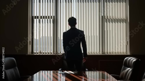 Businessman standing alone in meeting room.