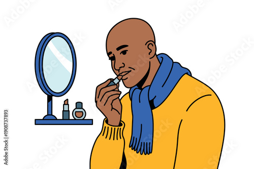 A bald man in a yellow sweater applies lip balm in front of a mirror with cosmetics
