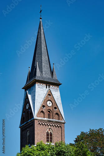 Slika na platnu Detail of the neogothic brick steeple and clock of the Catholic parish church St