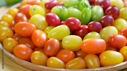 Colorful premium cherry tomatoes in red, yellow, orange and green tones filling the frame, fresh organic produce concept for healthy eating, vegan diet and farm to table food video